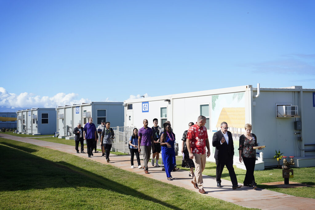 Kamehameha III Elementary School Principal Ian Haskins, left, leads U.S. Department of Education Sec. Miguel Cardona and Hawaii DOE Complex Area Superintendent Rebecca Winkie on a tour of their temporary campus Friday, Dec. 6, 2024, in Lahaina. (Kevin Fujii/Civil Beat/2024)