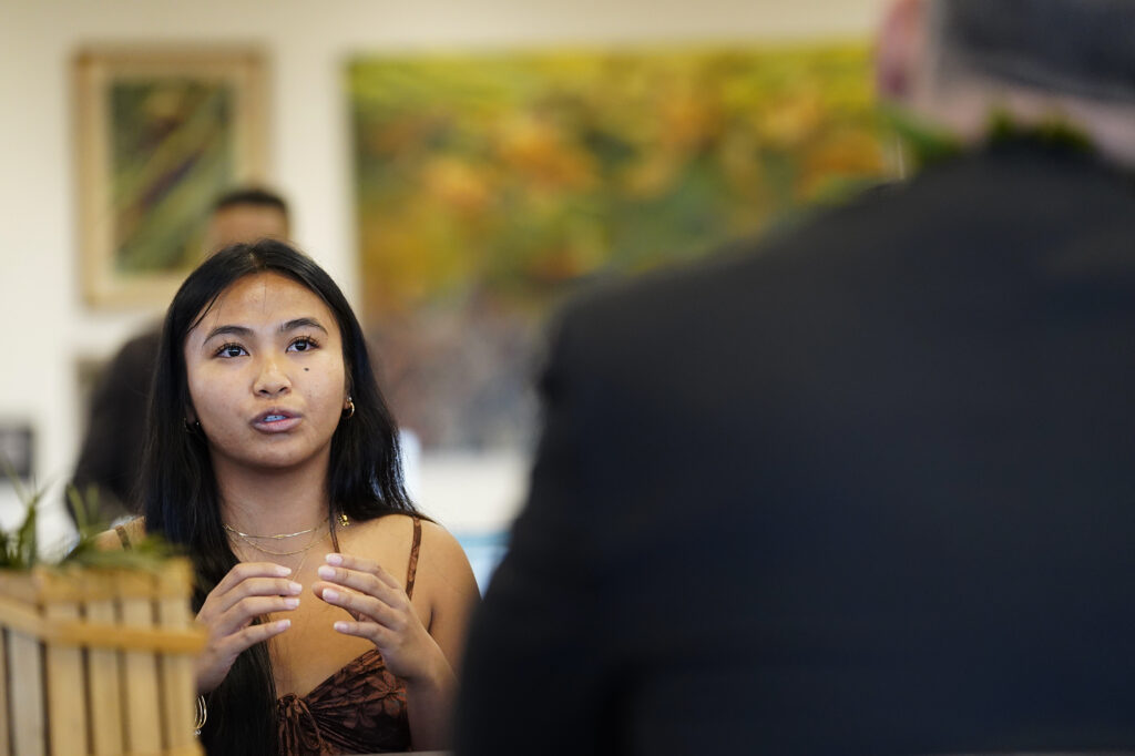 Lahainaluna High School student leader Karisa Bayudan, talks with U.S. Department of Education Sec. Miguel Cardona during his West Maui tour Friday, Dec. 6, 2024, in Lahaina. (Kevin Fujii/Civil Beat/2024)